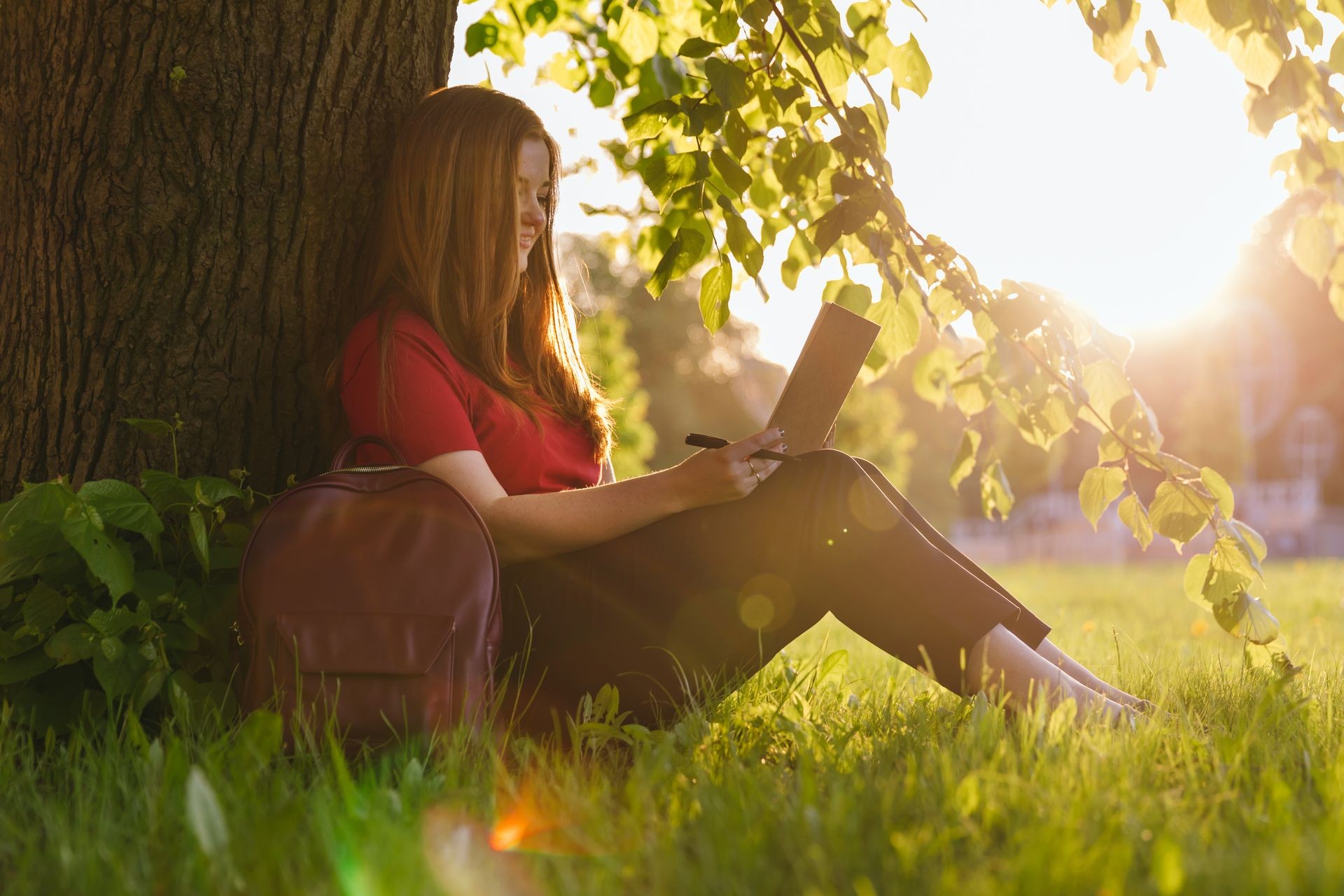 Girl sitting in the summer park and planning her goals and ways with notes. Life coach goals concept